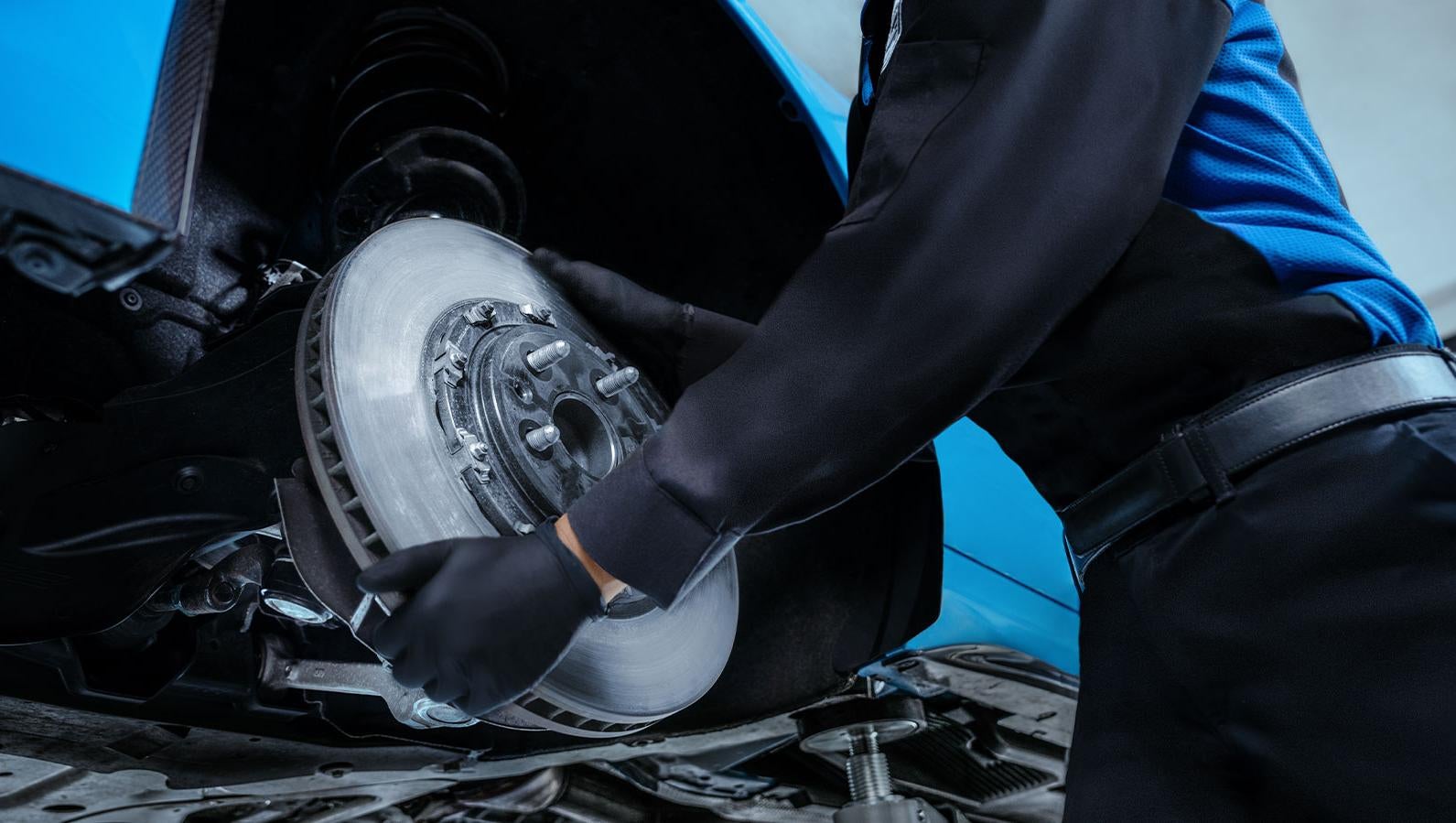 image of someone placing a brake on a car